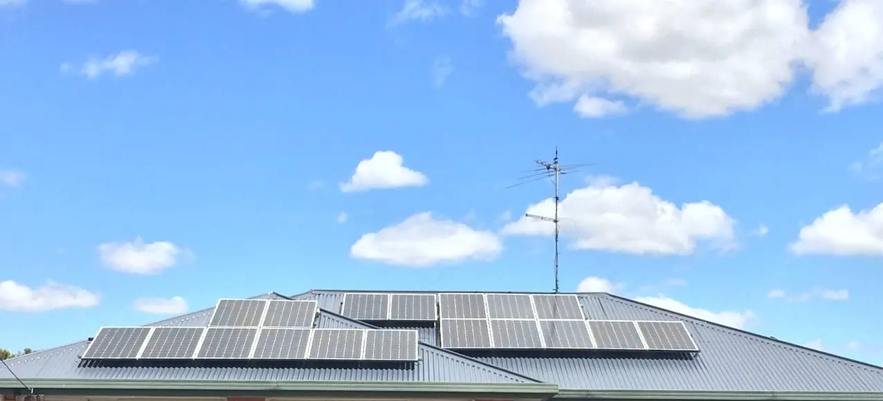 Completed dark metal roof surrounding existing solar panels in Launceston Tasmania