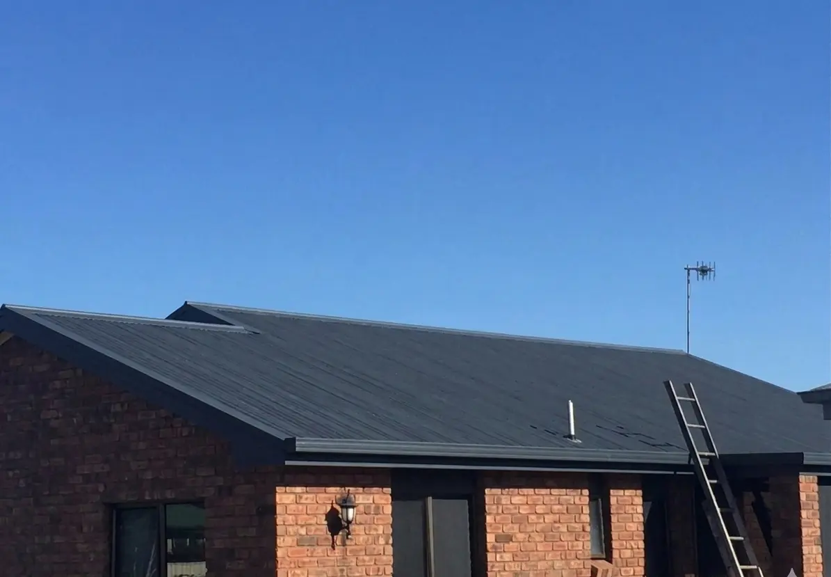 Charcoal corrugated roof on a brick home