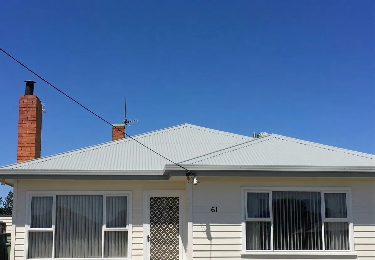 Fresh white metal roof on a weatherboard home