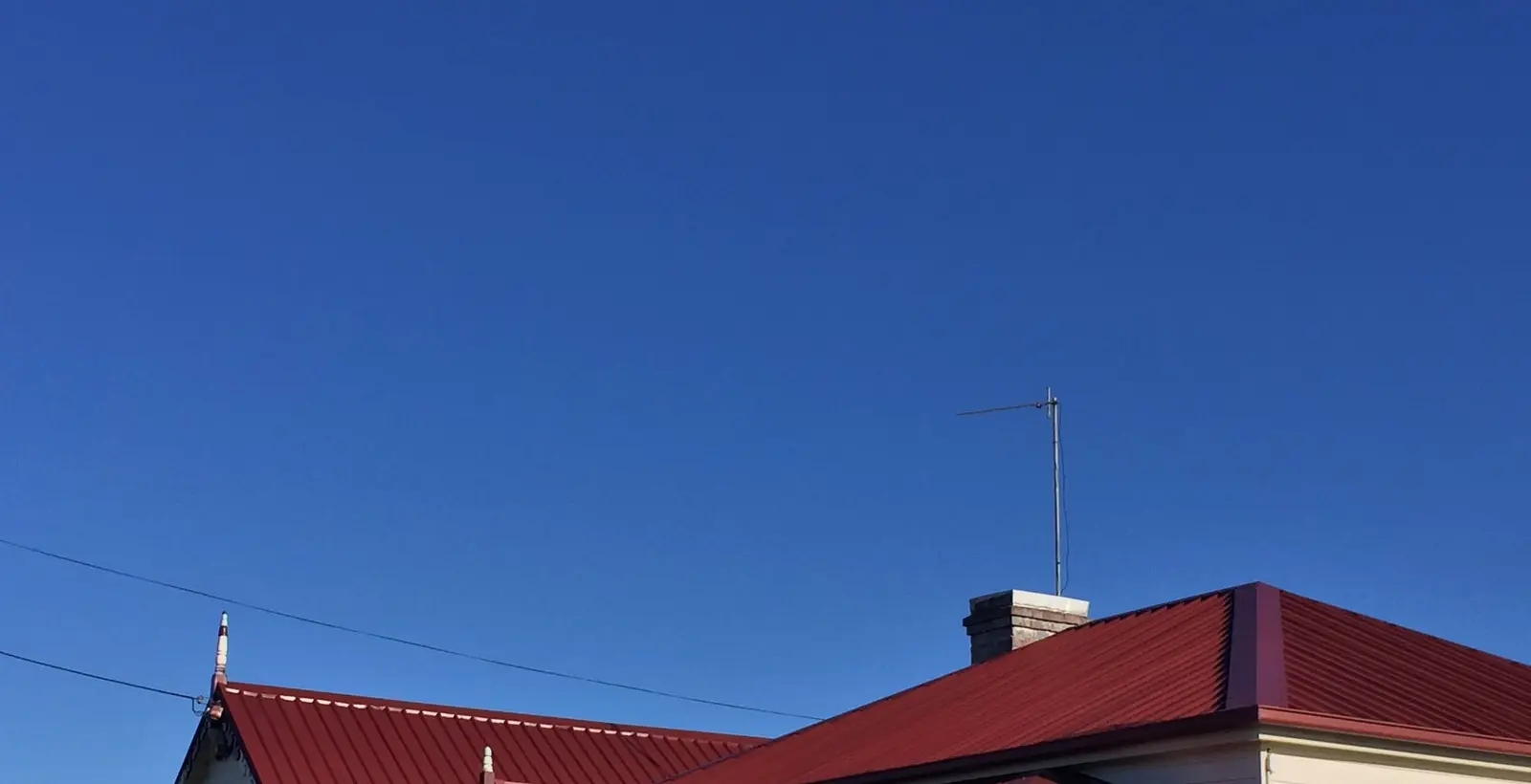 Deep red metal roof after repainting at the Ulverstone property